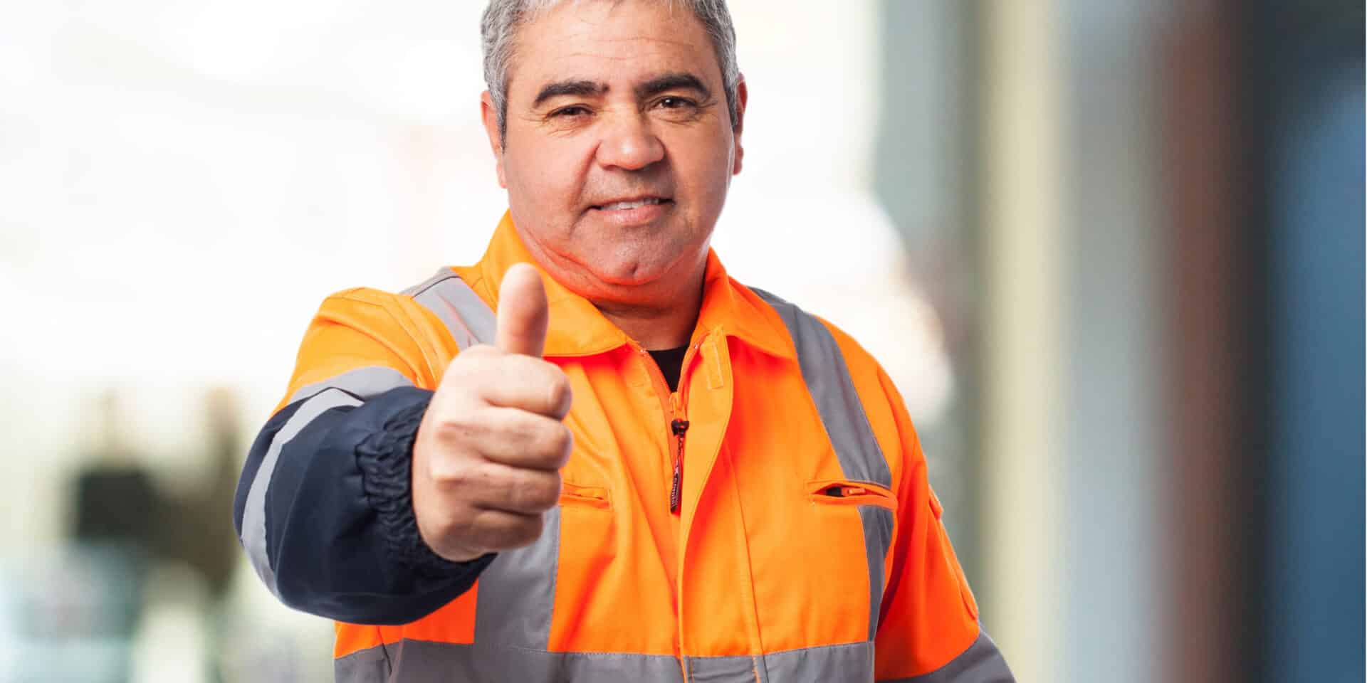 portrait of a outdoor worker doing an okay symbol