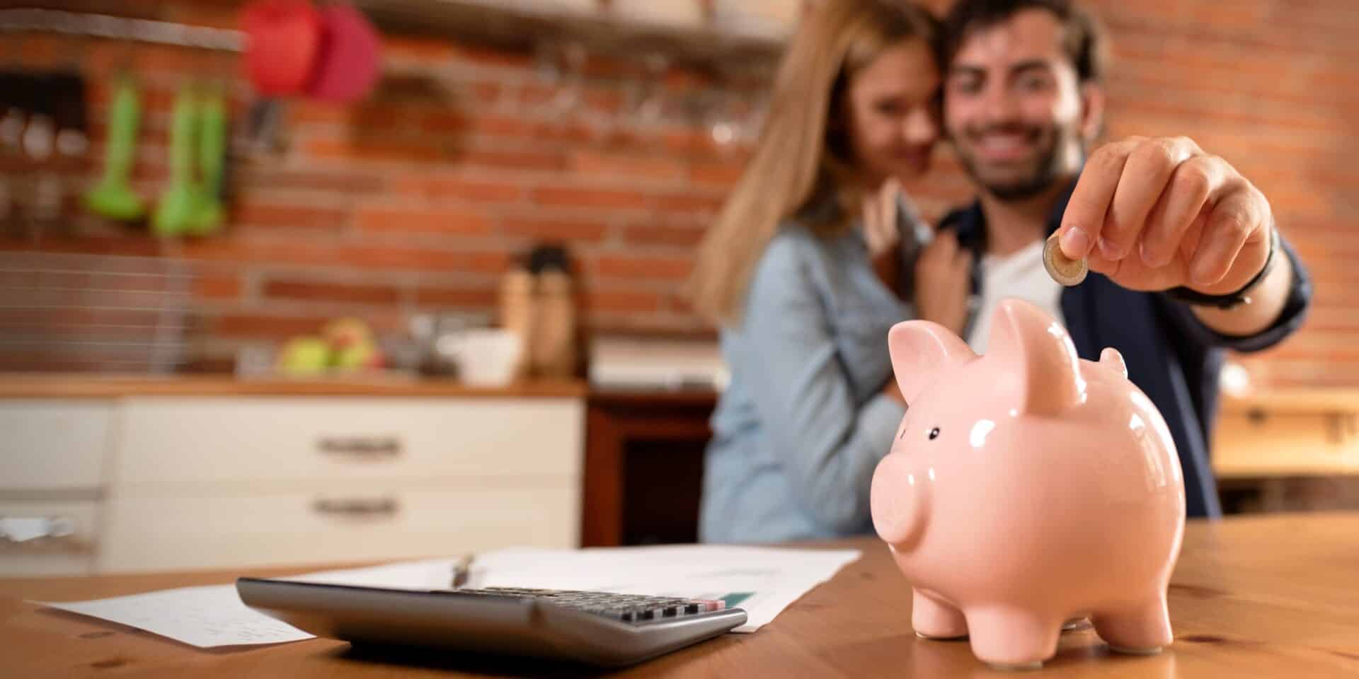 Happy,Couple,Inserting,Coin,In,Piggybank.,Home,Budget,,Family,Finance