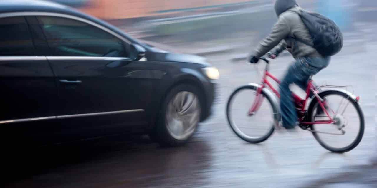 Dangerous city traffic situation with cyclist and car
