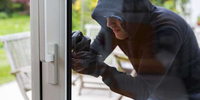 Burglar using special tools to break in  a house