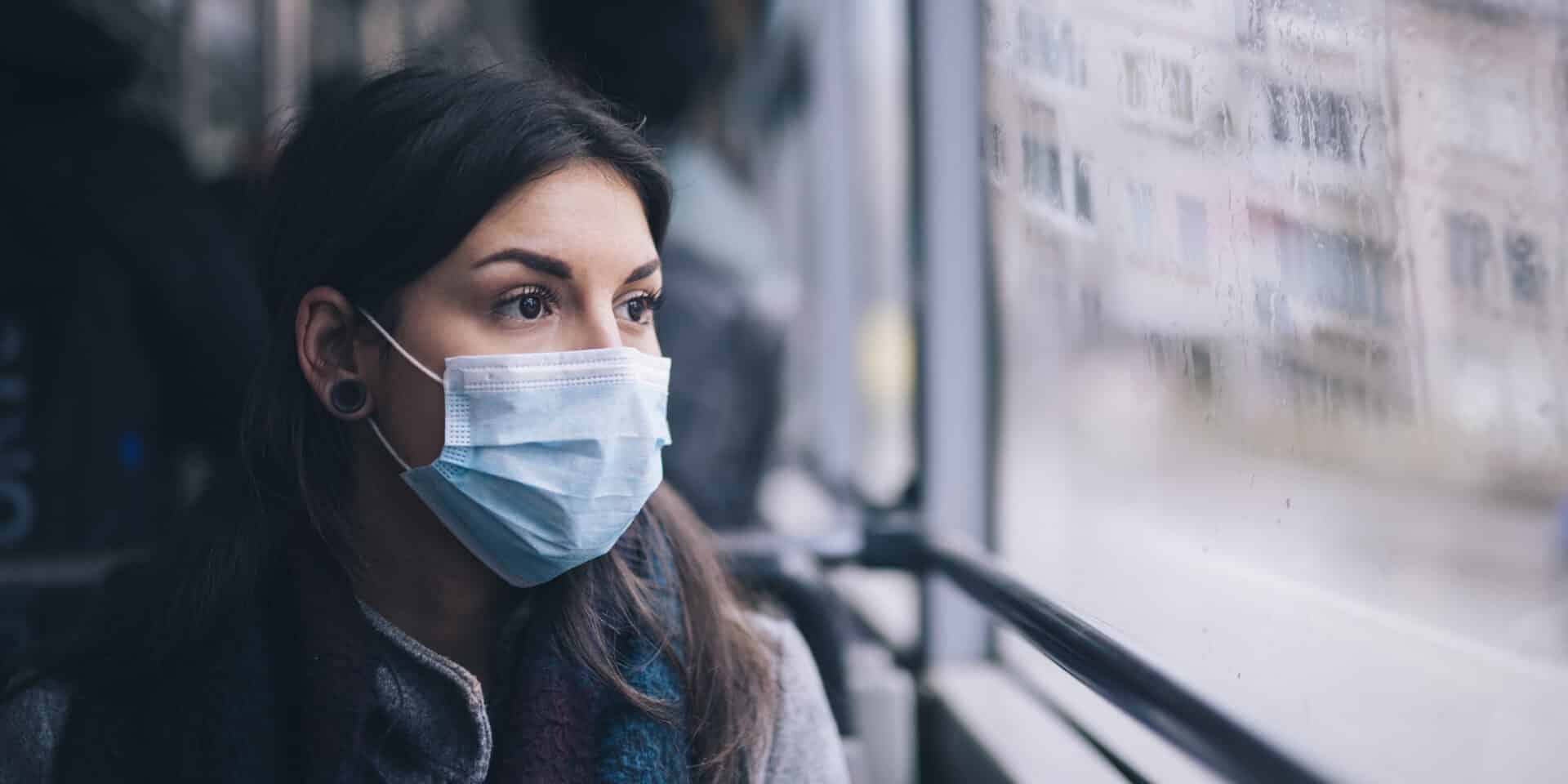 Worried Woman With Protective Face Mask In Bus Transport.