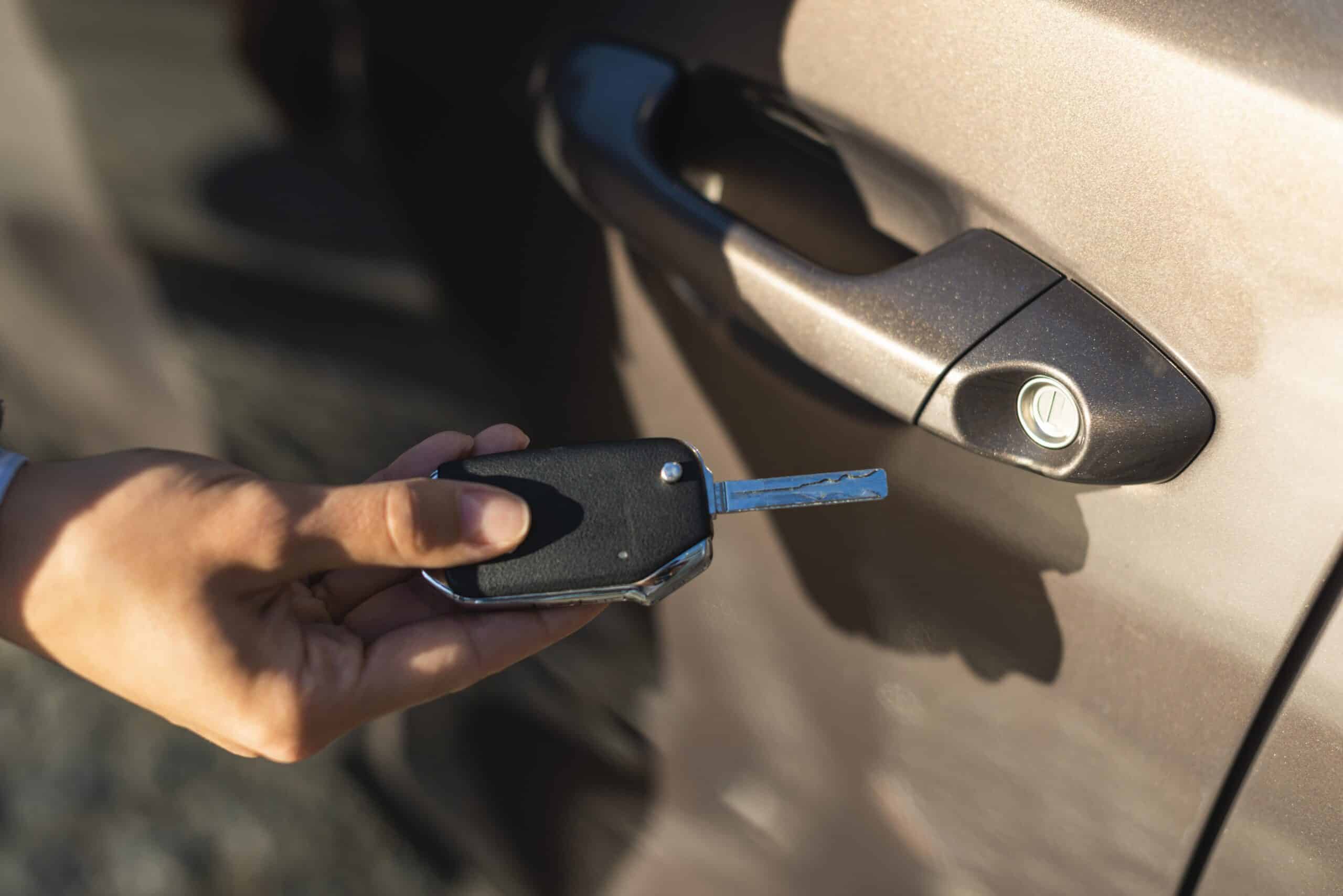 businesswoman-using-key-unlock-her-car-door