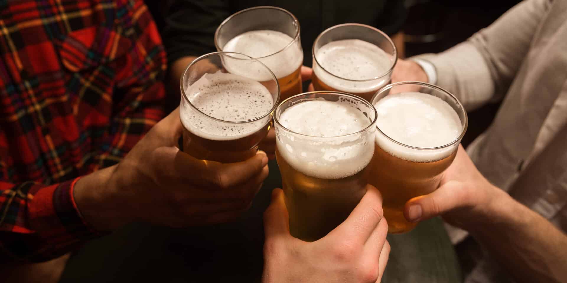 Close-up of men toasting with beer