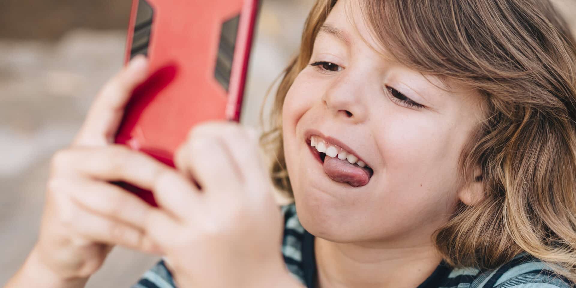 close-up-kid-playing-phone