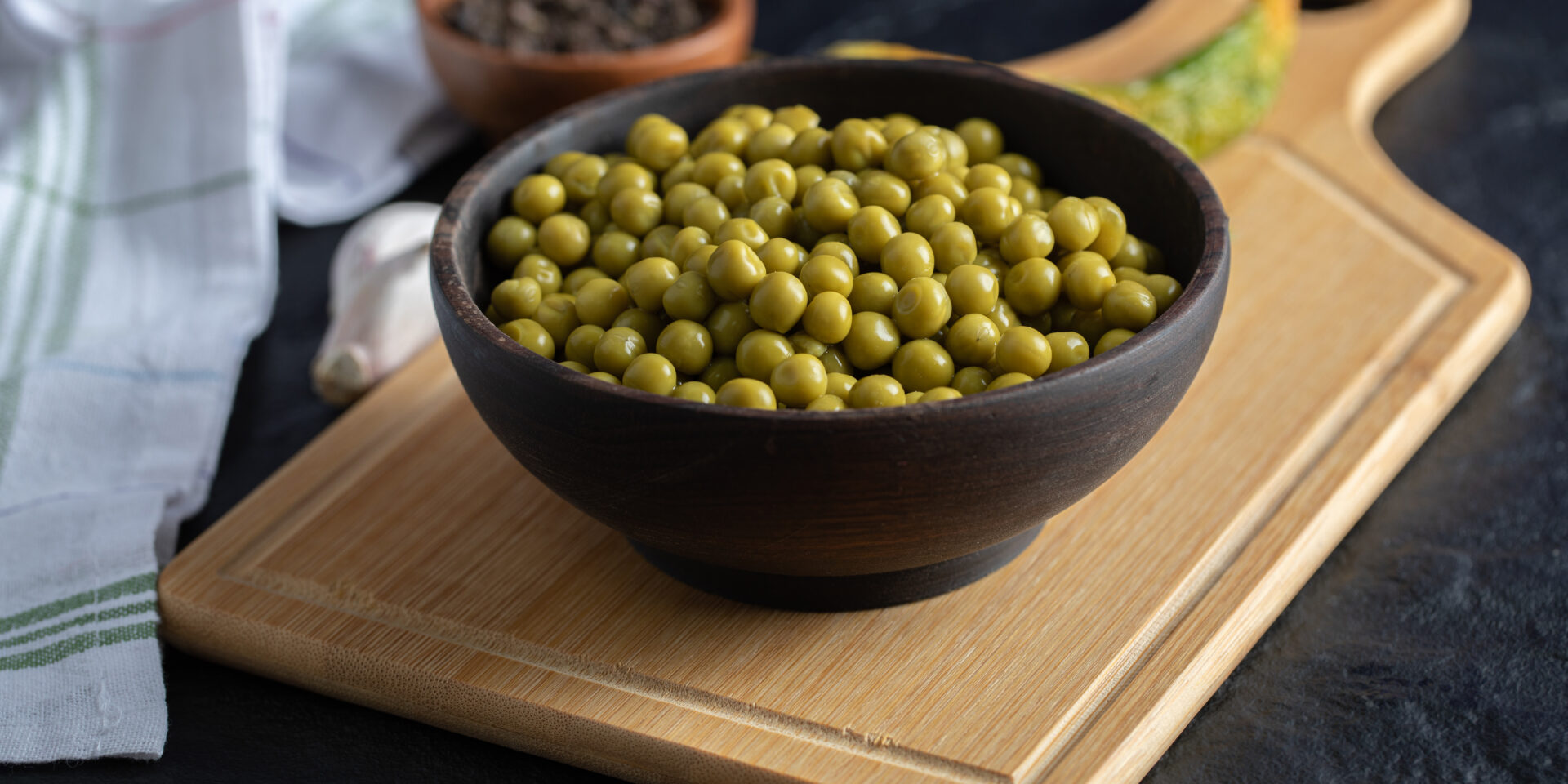 Bowl canned olives on wooden board