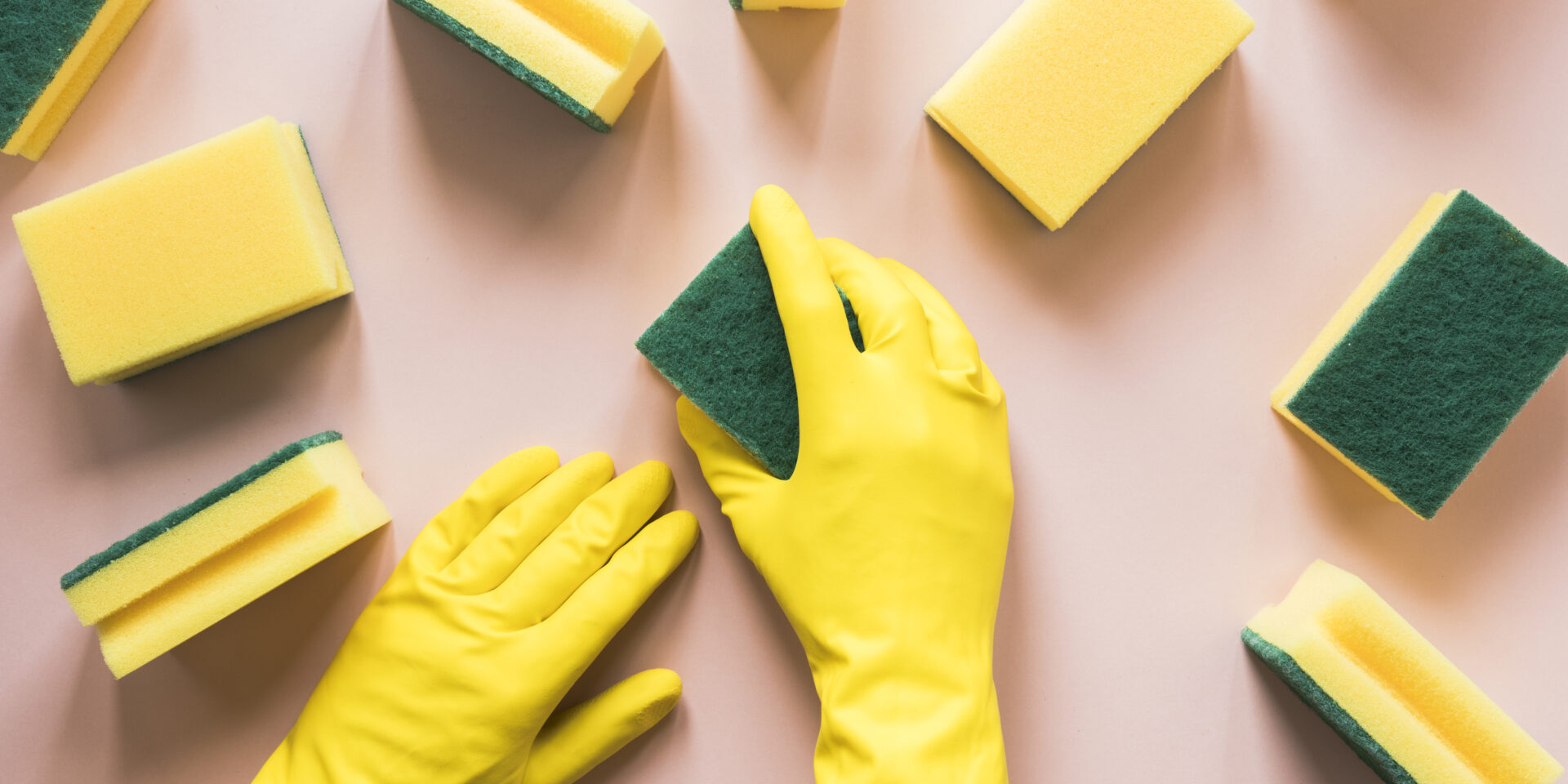 close-up-person-with-yellow-gloves-sponges