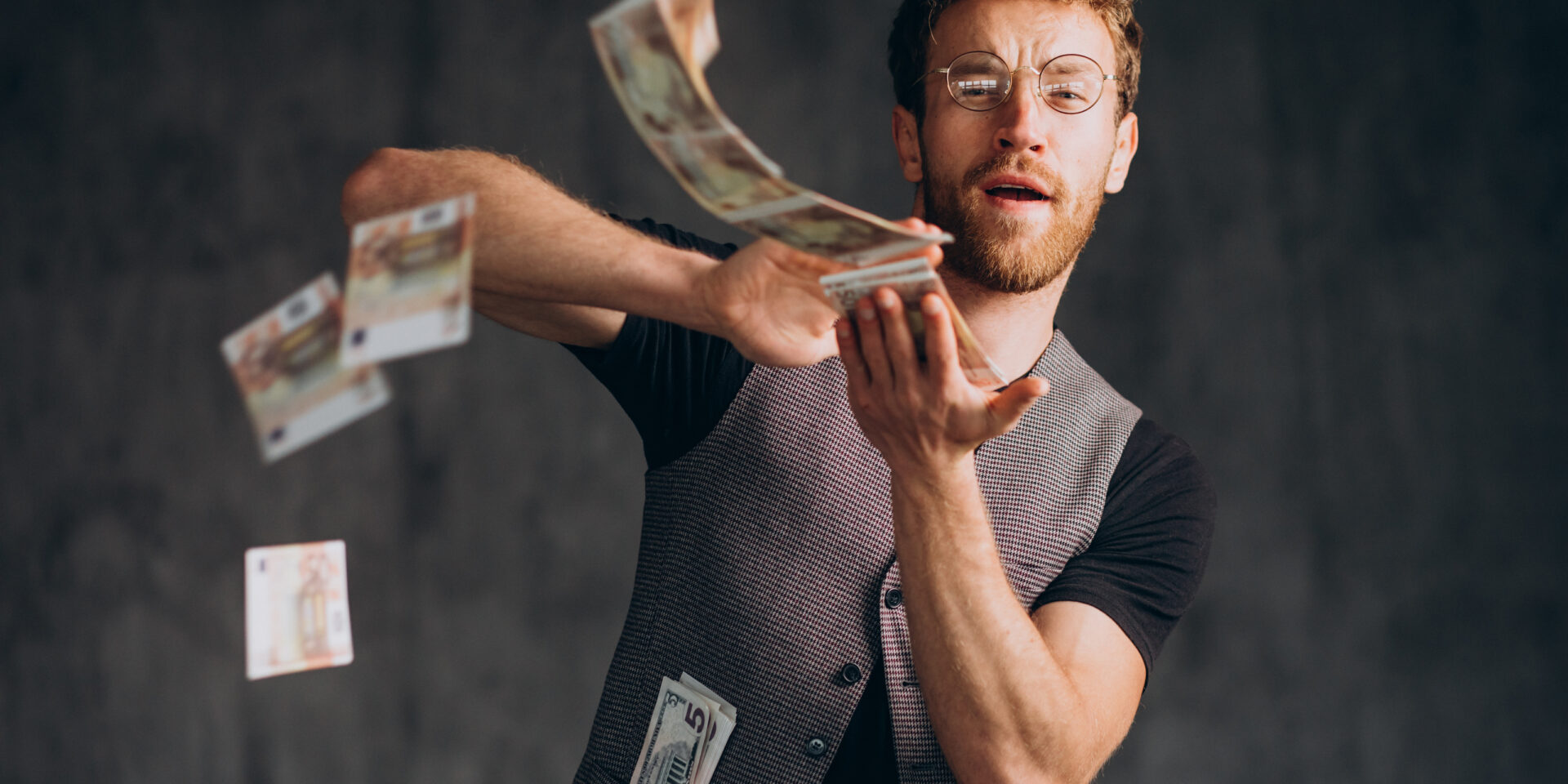Man with banknotes isolated in studio