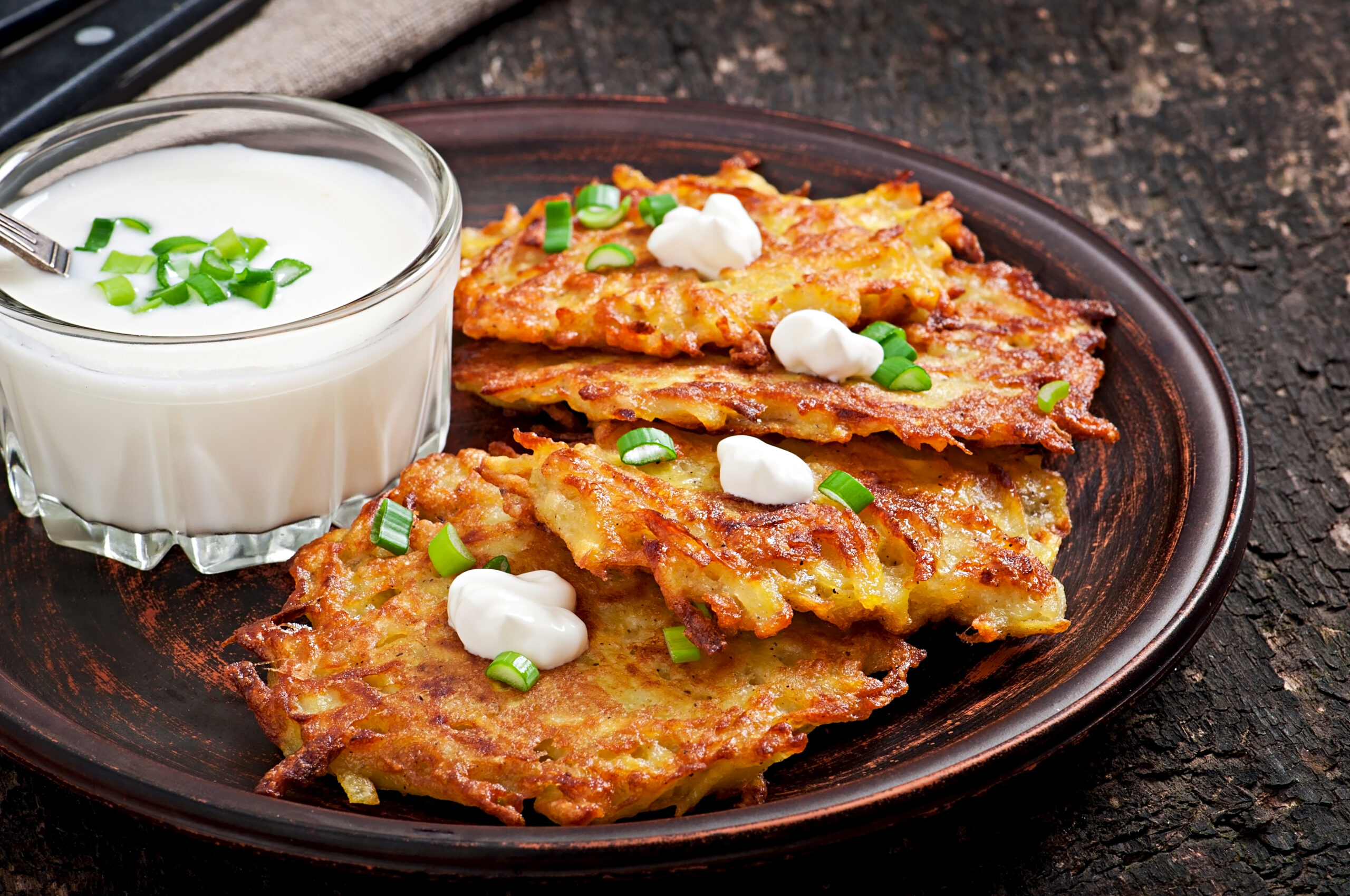 Fried potato pancakes on the old wooden background