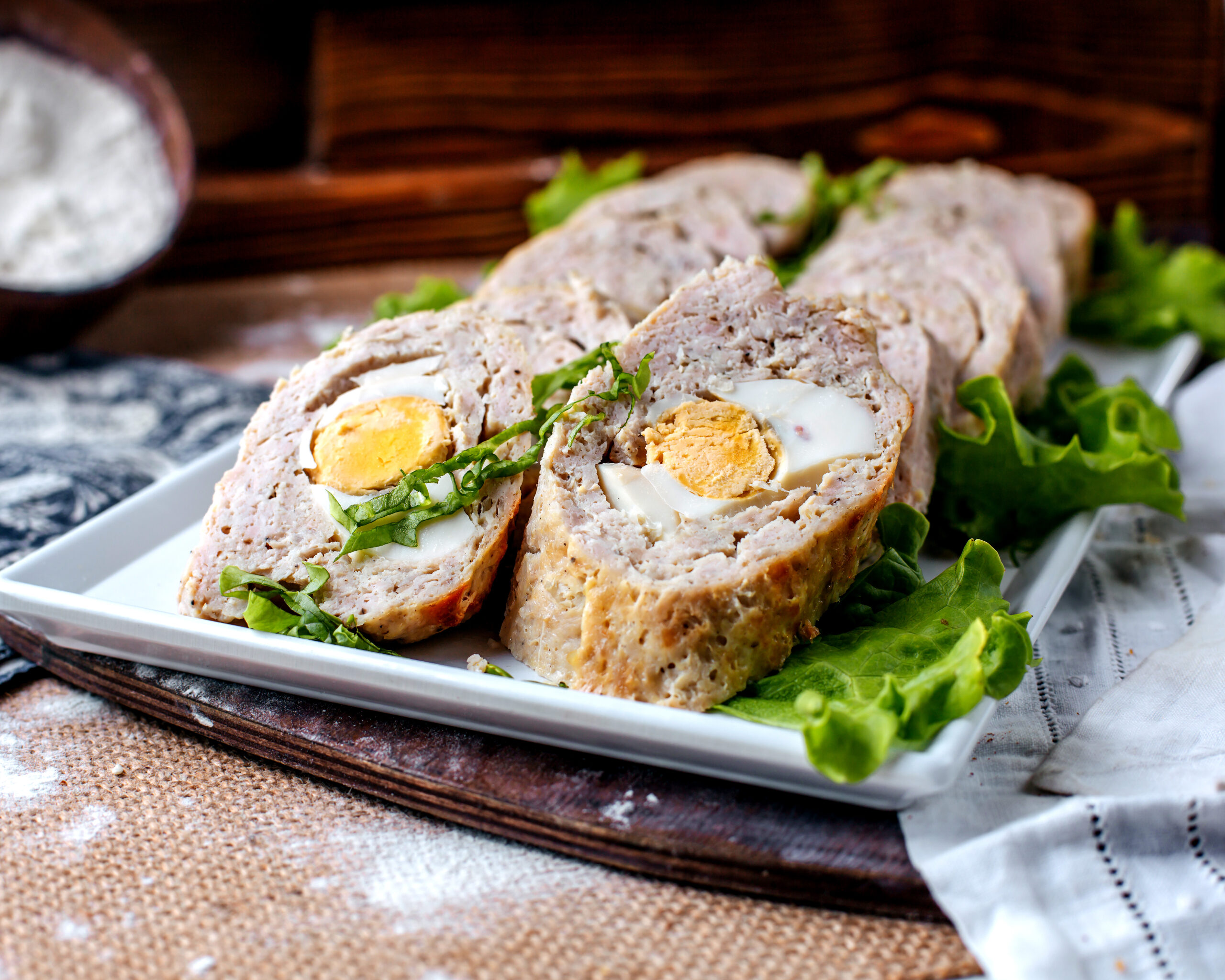 front-view-rolls-pate-tasty-yummy-with-green-salad-inside-white-plate-brown-surface