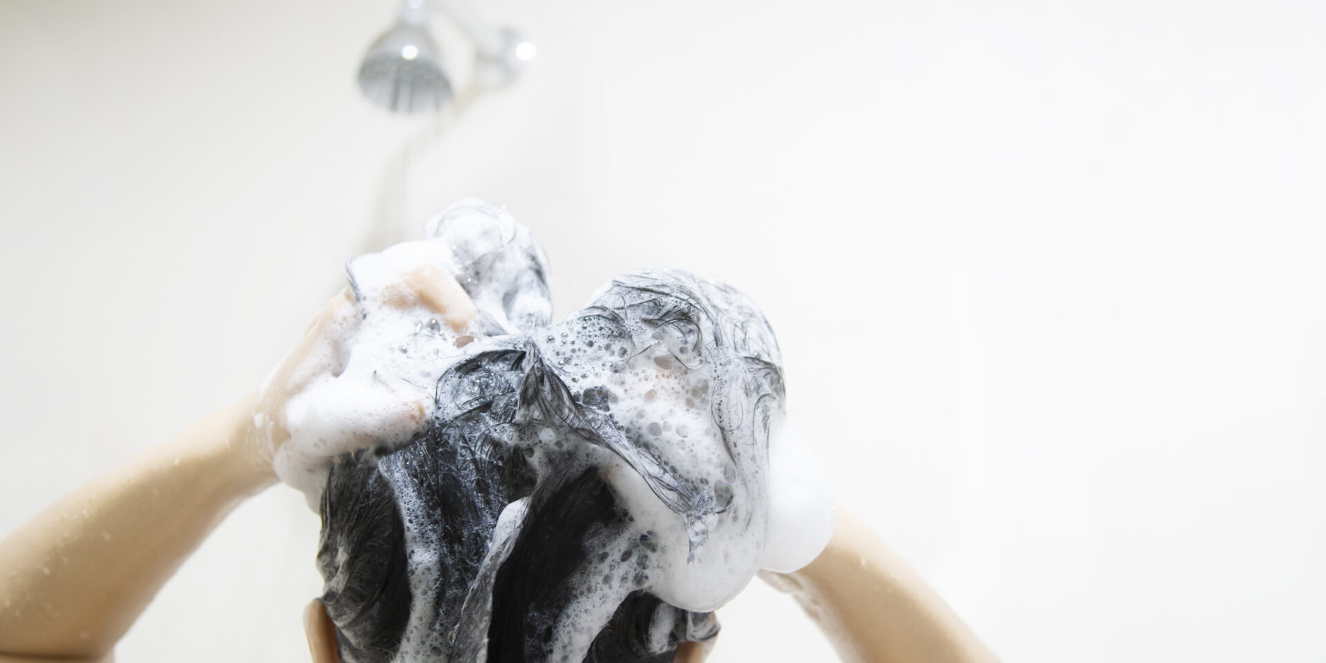 lady-using-shampoo-wash-clean-her-hair-bathroom-with-splash-shower-spray-water
