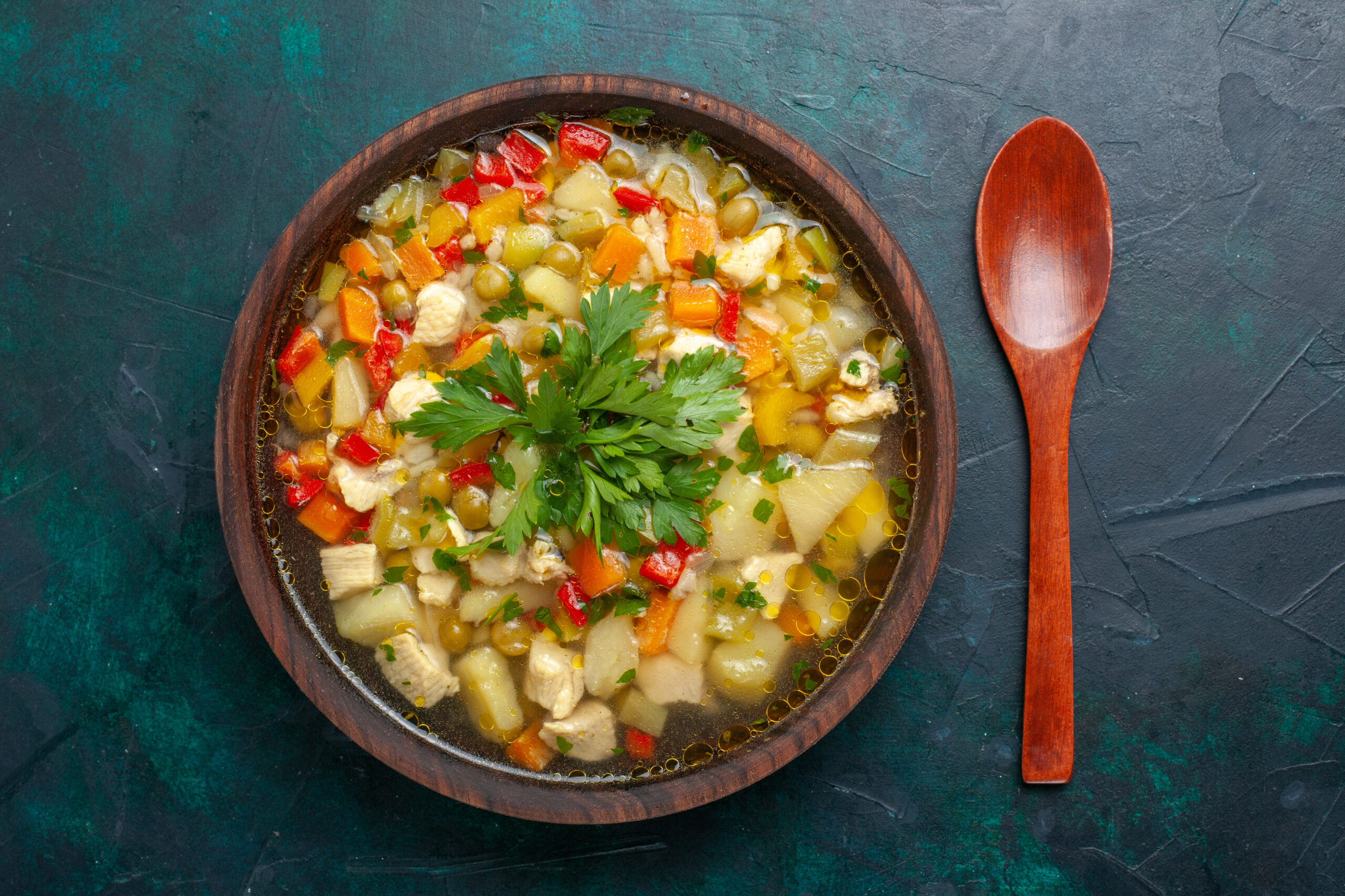 top-view-delicious-vegetable-soup-with-different-ingredients-inside-brown-plate-dark-desk-soup-vegetables-sauce-meal-food-hot-food