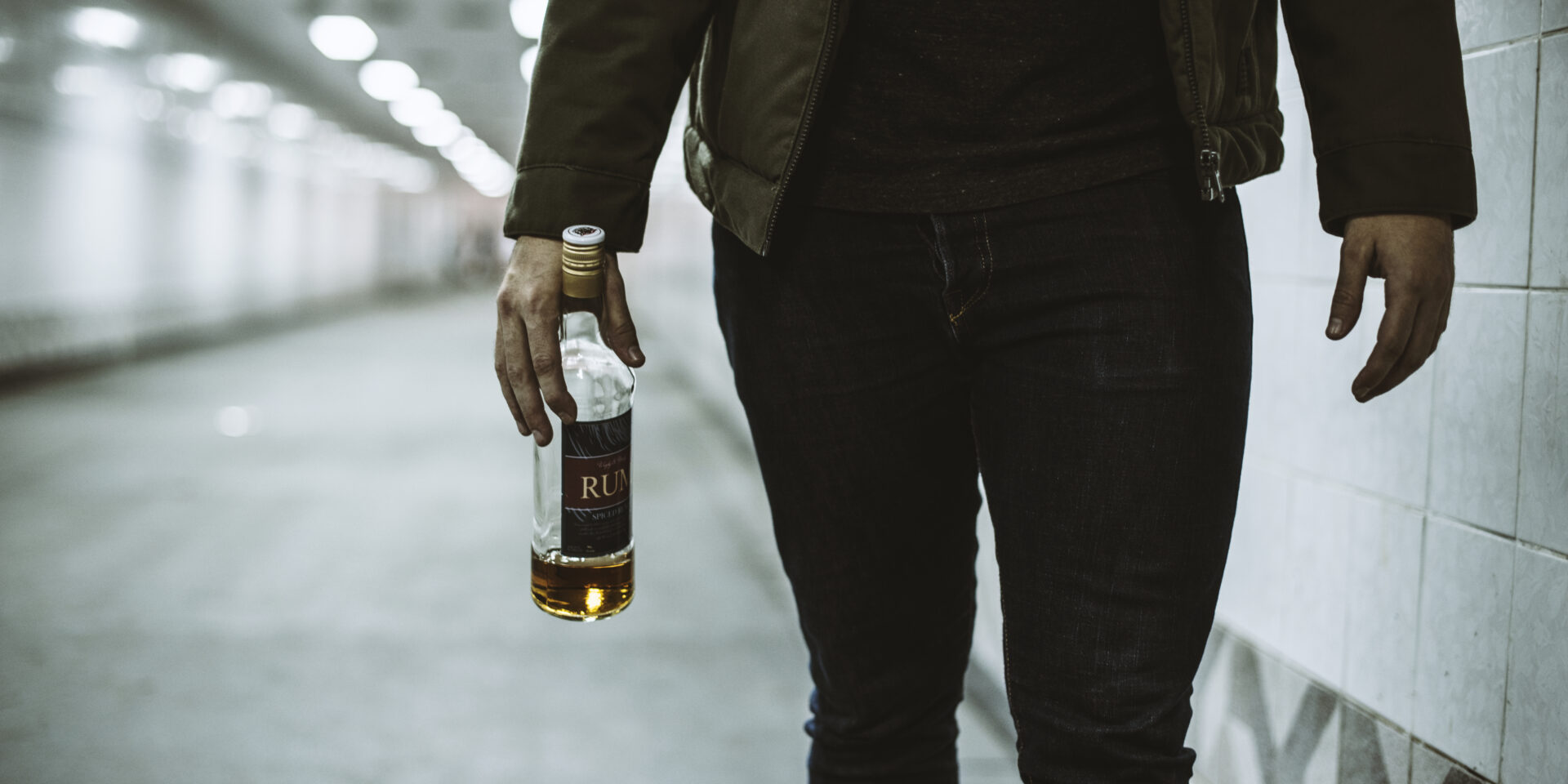 Alcoholic Homeless Holding Liquor Bottle