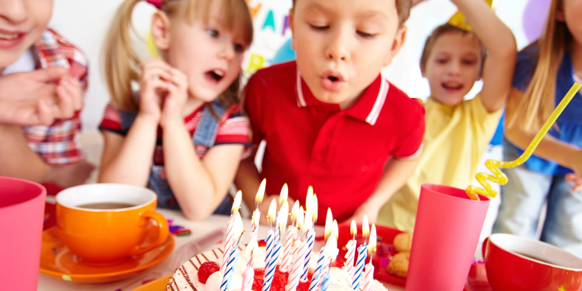 kids-blowing-candles-birthday-party