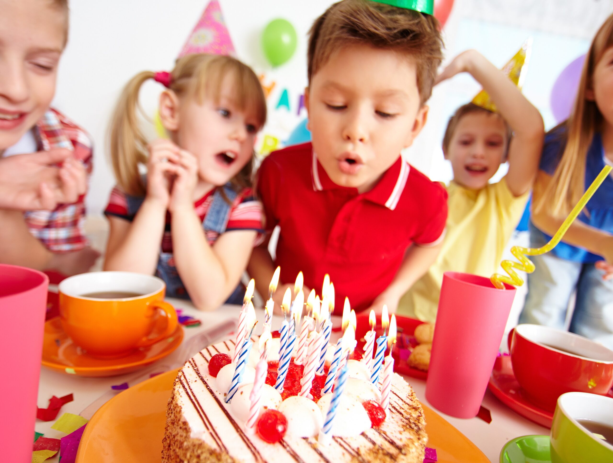 kids-blowing-candles-birthday-party