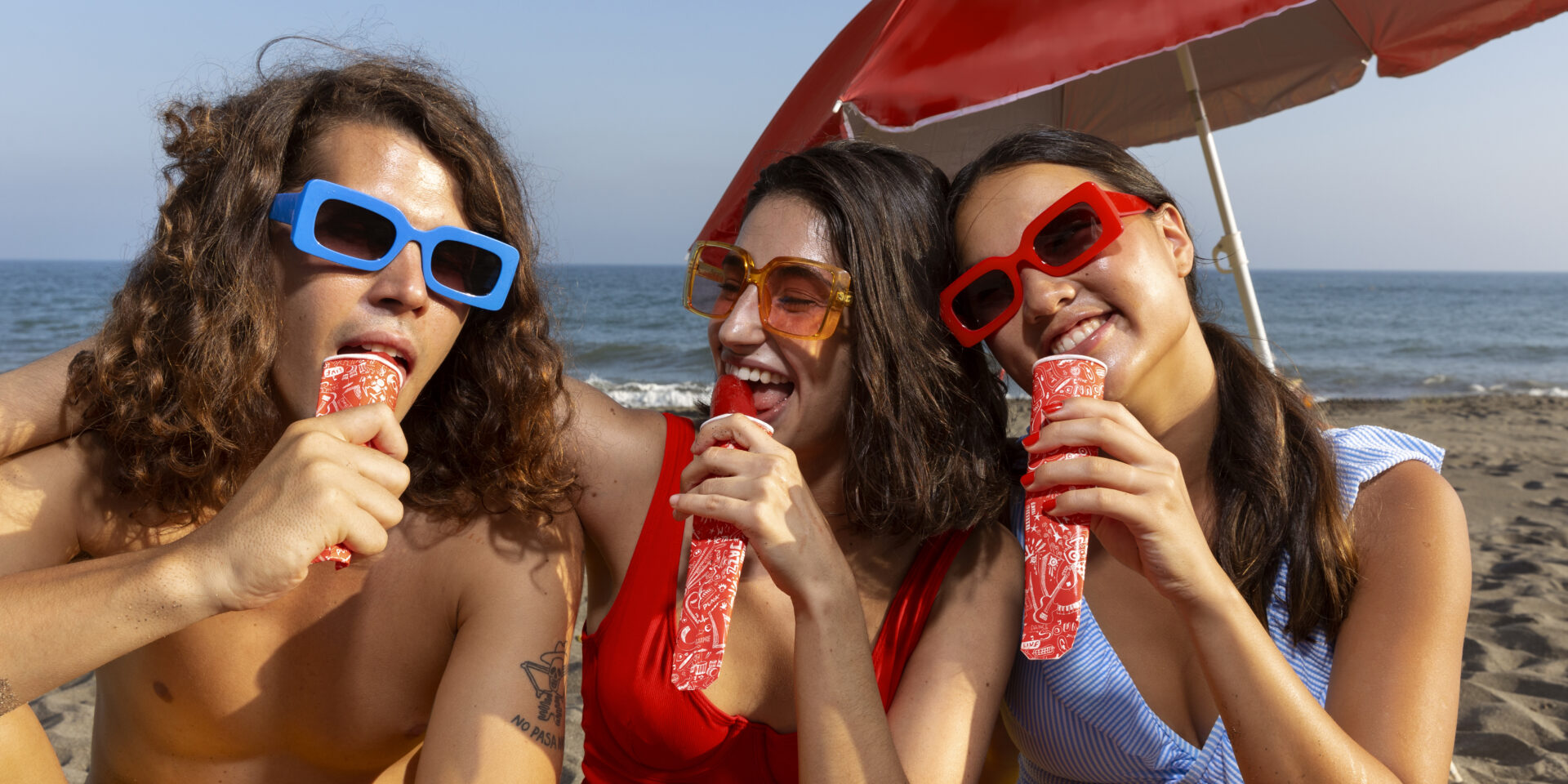 front-view-friends-eating-ice-cream-beach