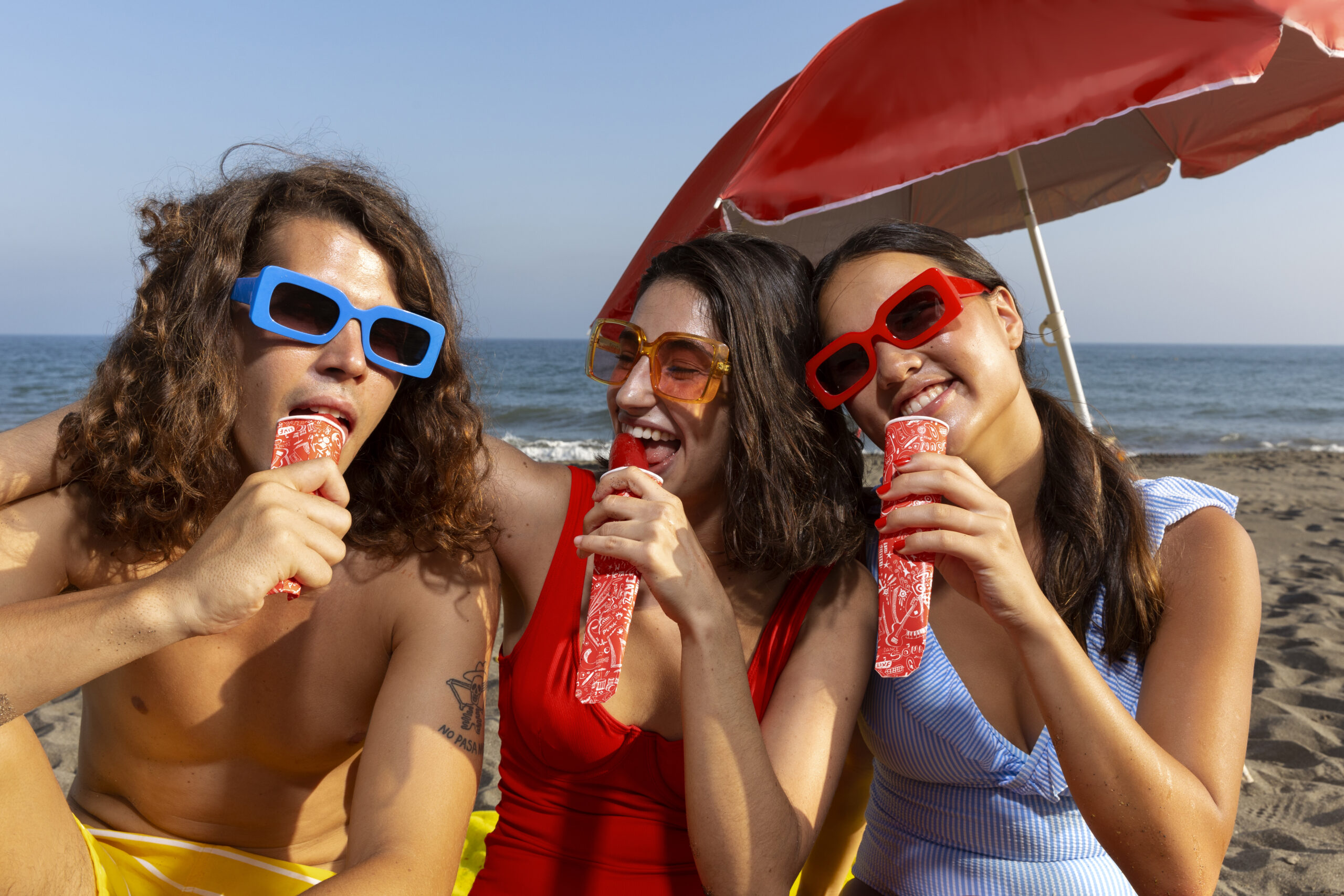 front-view-friends-eating-ice-cream-beach