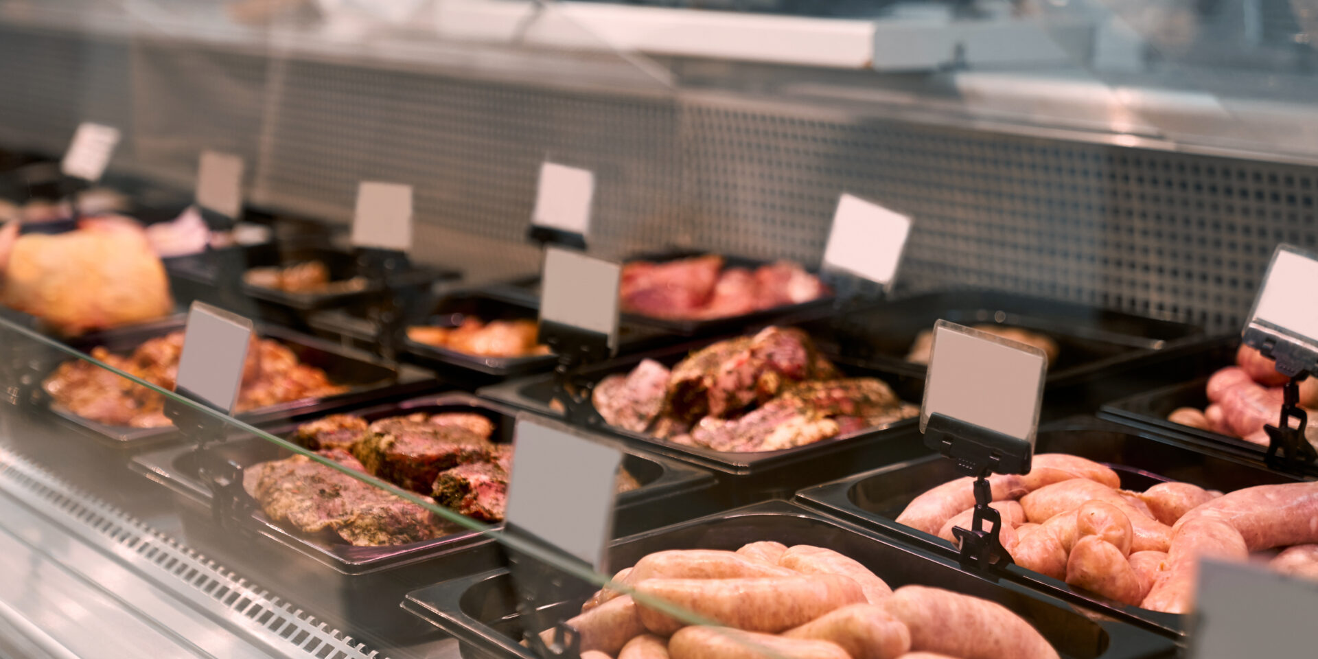 Raw meat products in glass counter.