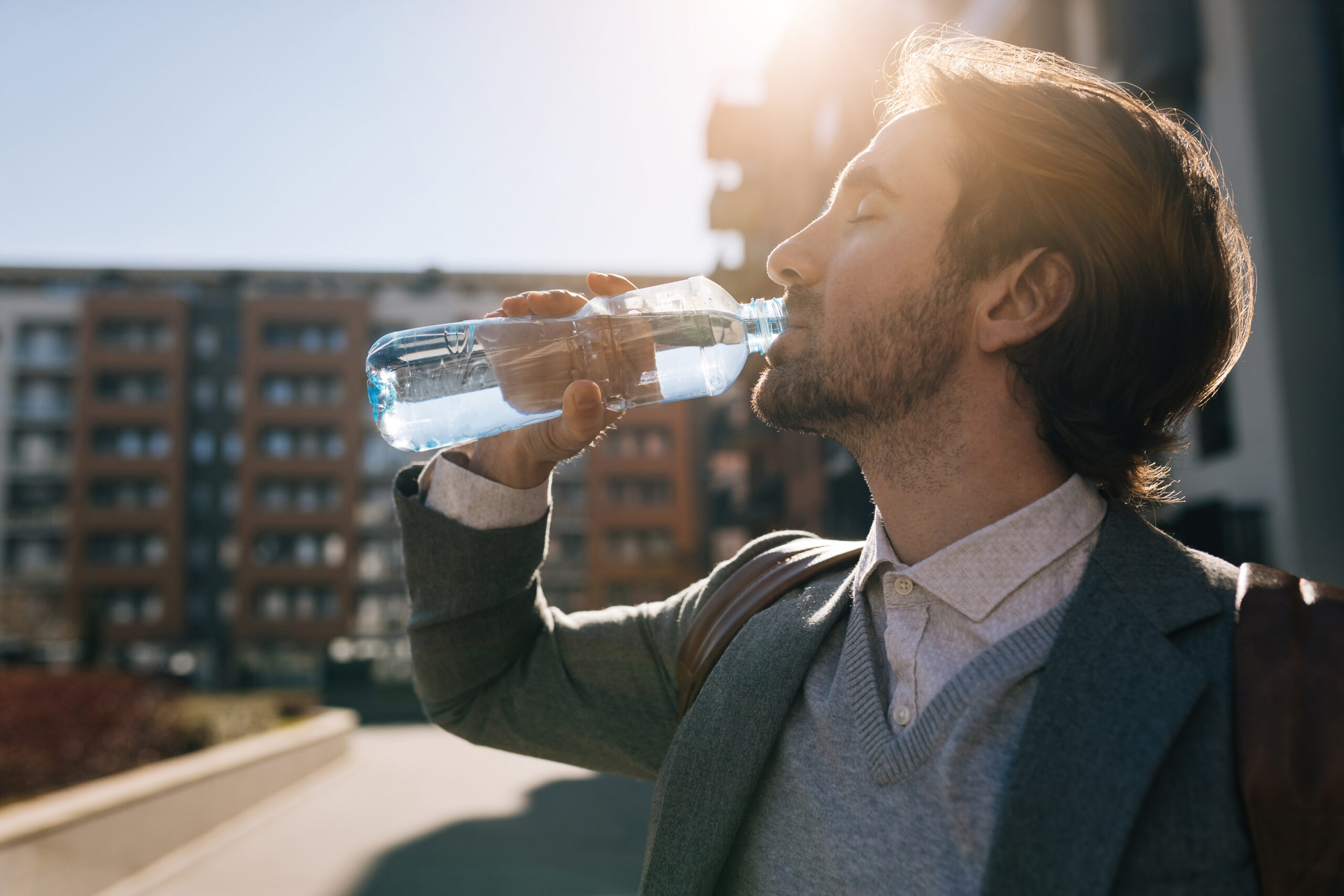 Profile view of businessman drinking water from a bottle in the