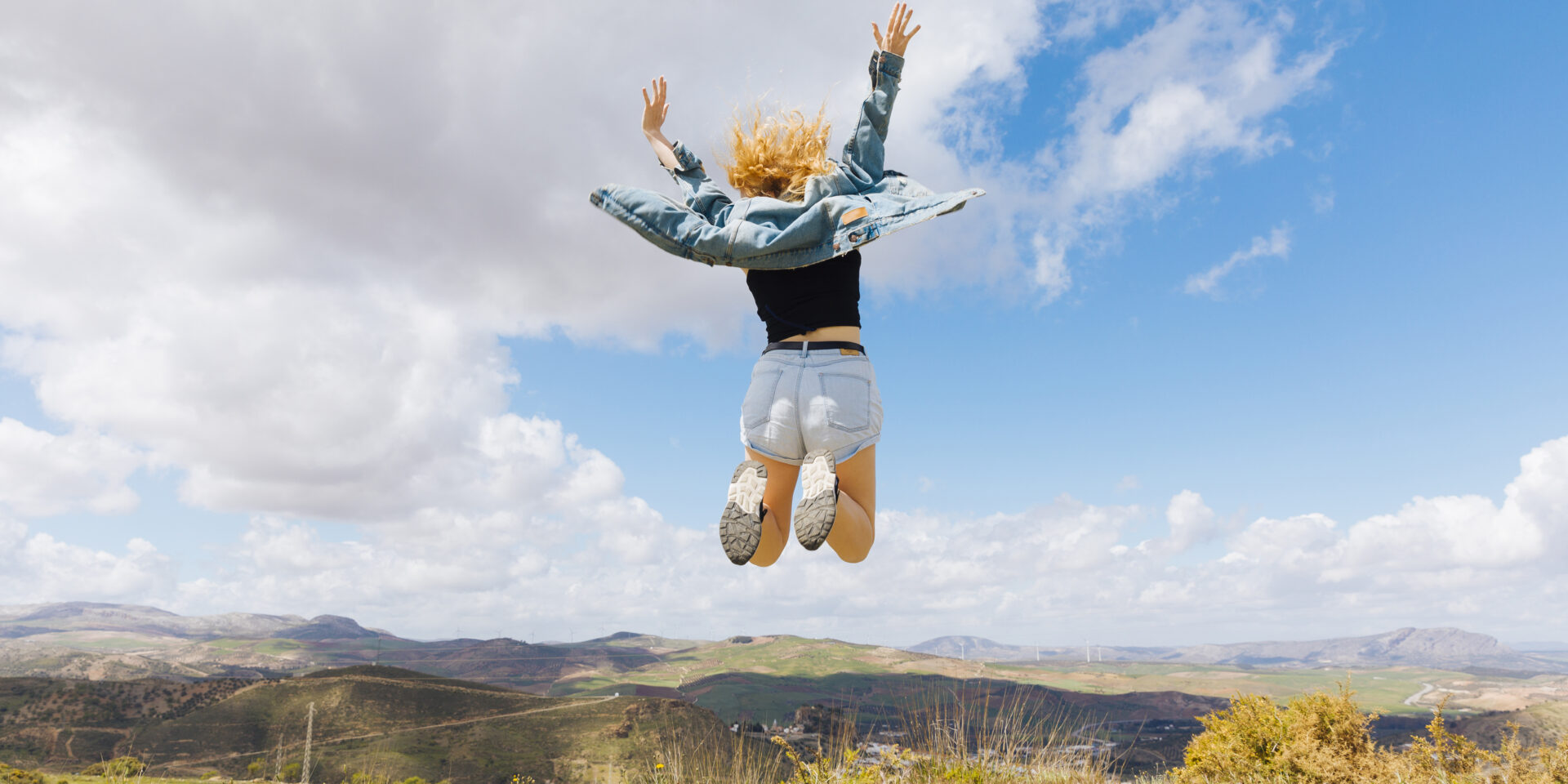 woman-jumping-joy-hilltop