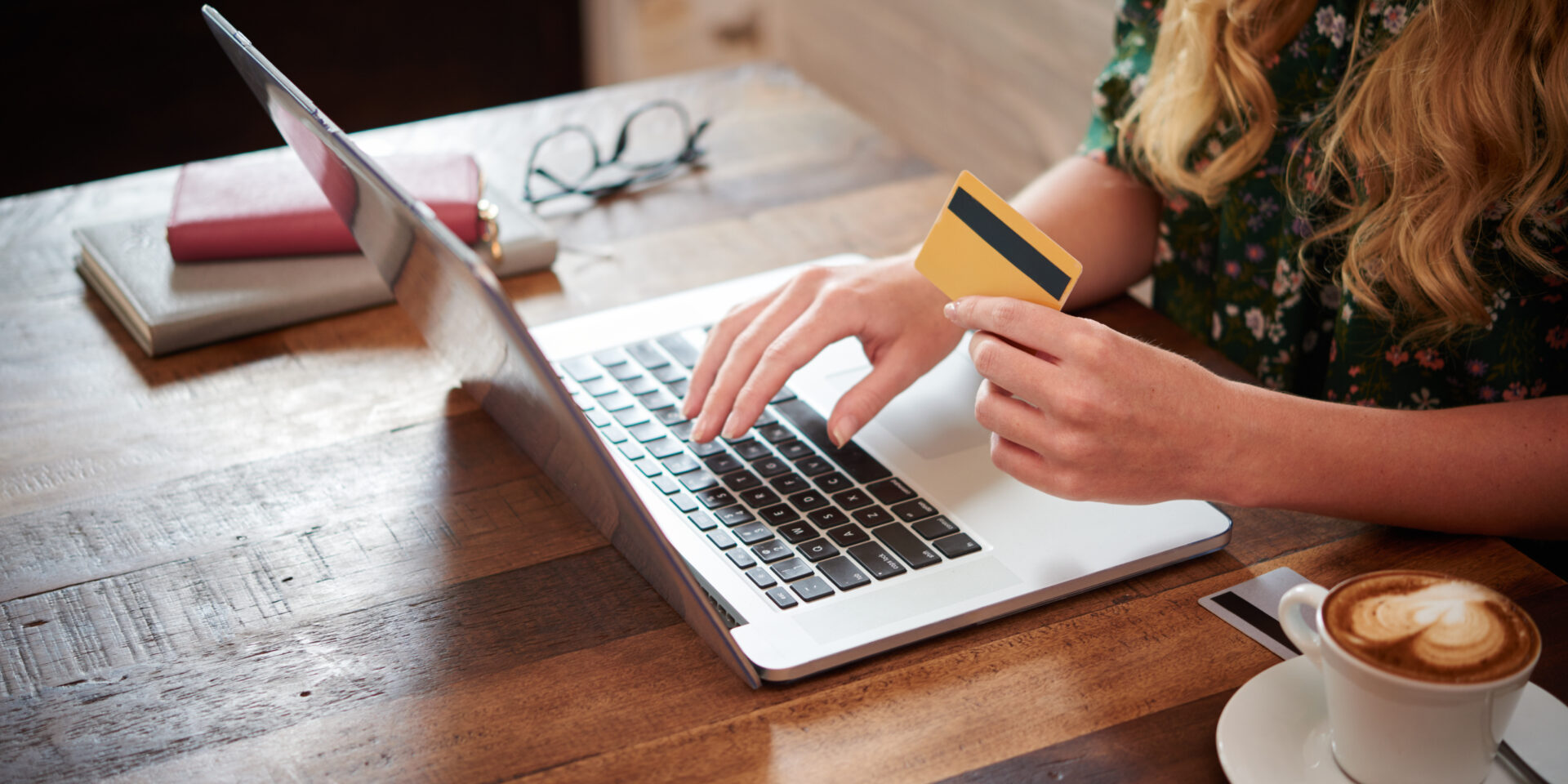 side-view-cropped-unrecognizable-blond-woman-typing-plastic-card-information-laptop