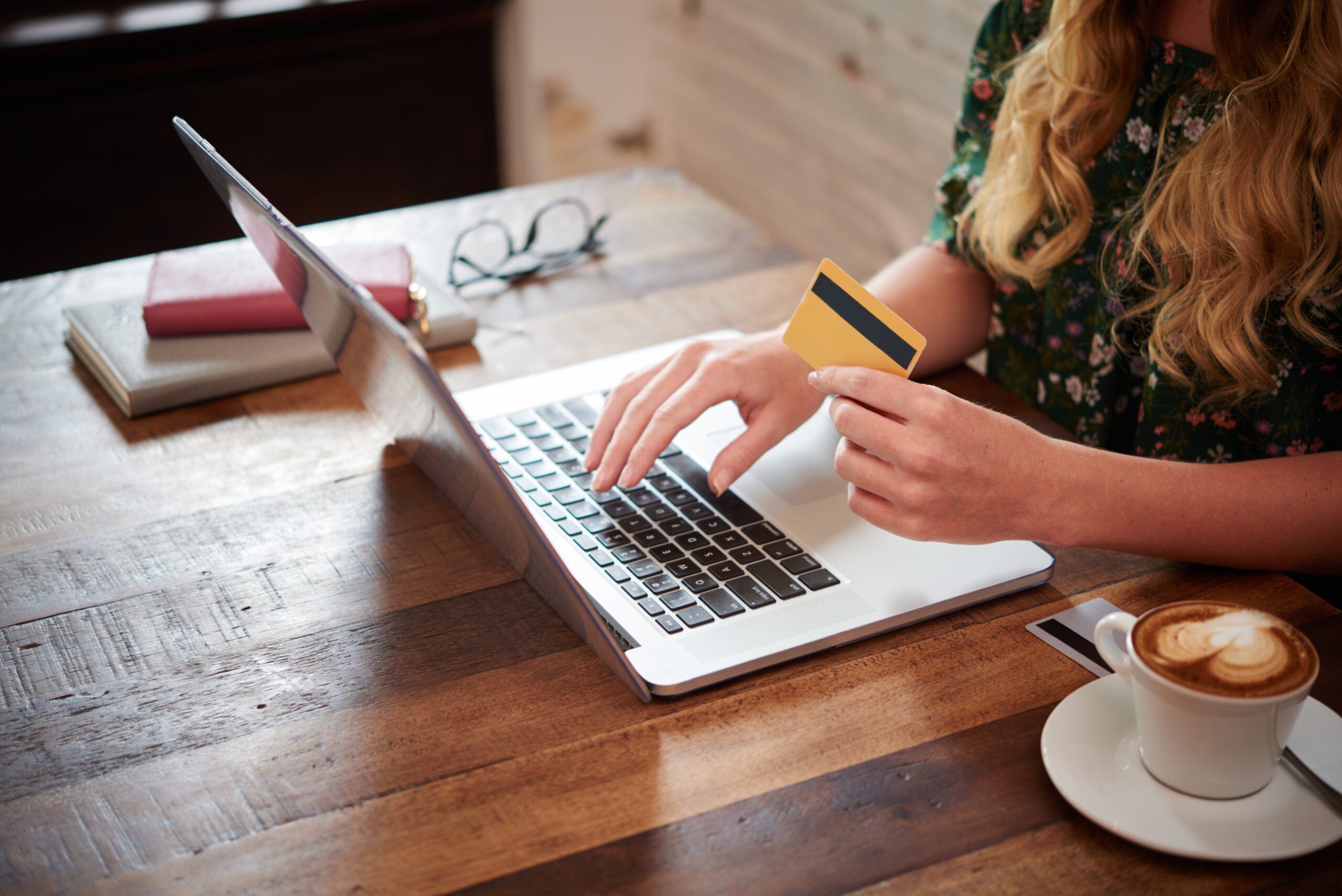 side-view-cropped-unrecognizable-blond-woman-typing-plastic-card-information-laptop