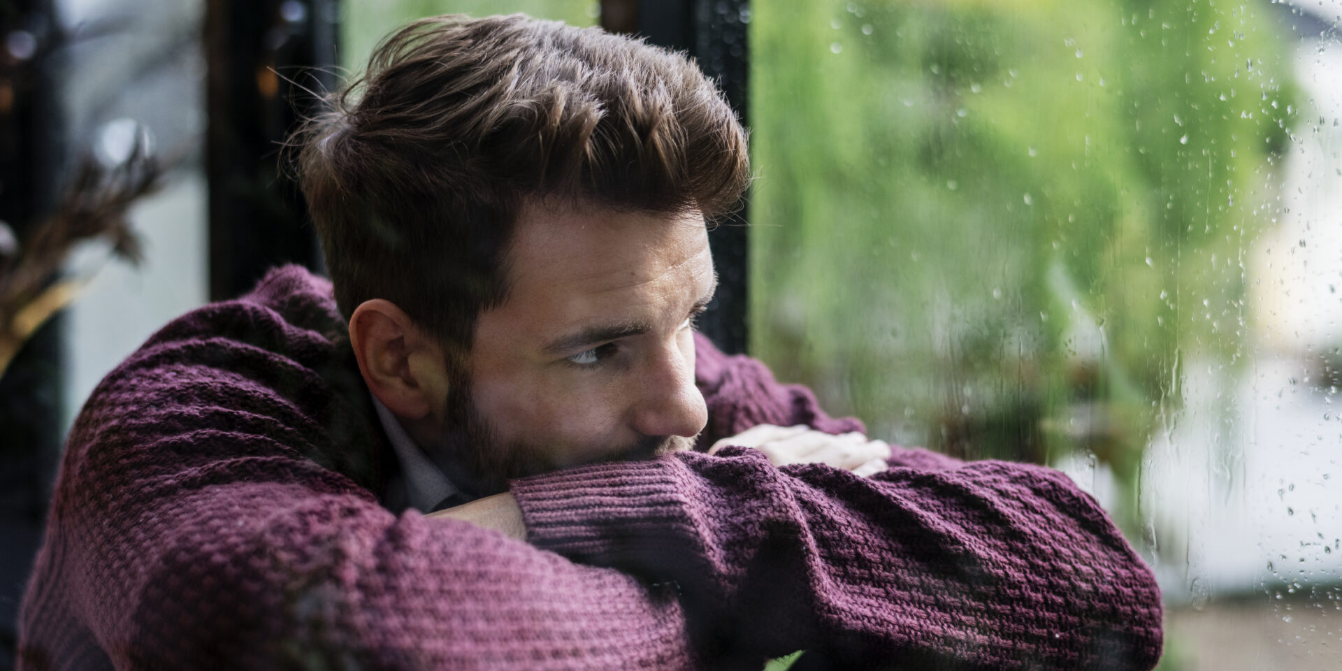 Thoughtful man looking out the window