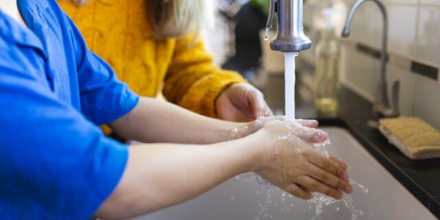 Boy washing hands in the new normal